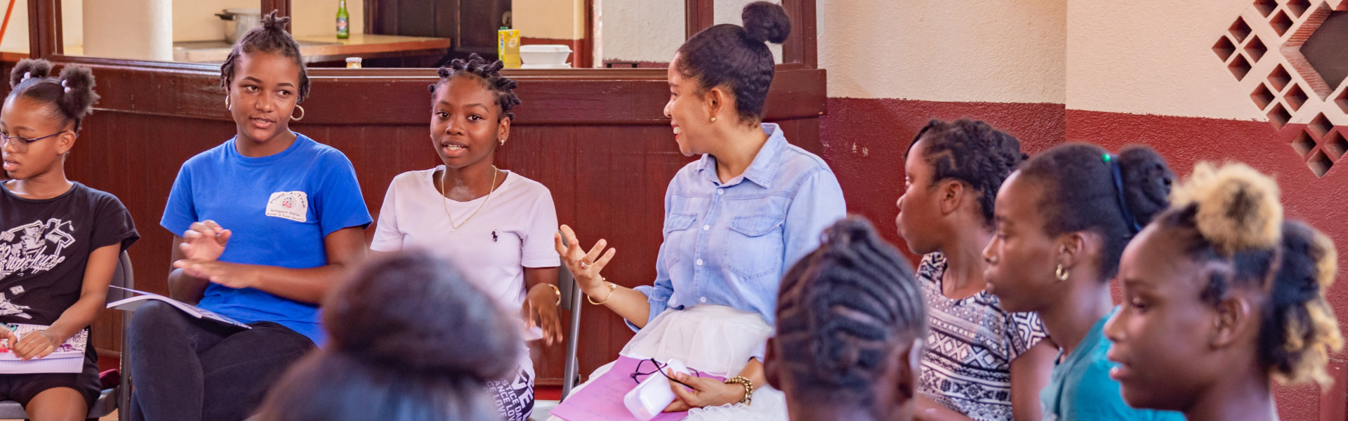 A group of student having a meeting lead by their teacher